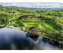 The Best Feng Shui House For Sale, surrounded by reservoir and mountains.